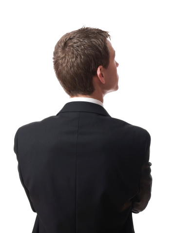 back of pensive young businessman looking up isolated on white background