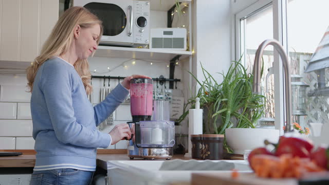 Happy woman, smoothie and blender in kitchen with detox, fruits and nutrition drink at home. Breakfast, weight loss and female person smile with cooking and nutritionist food in the morning in house