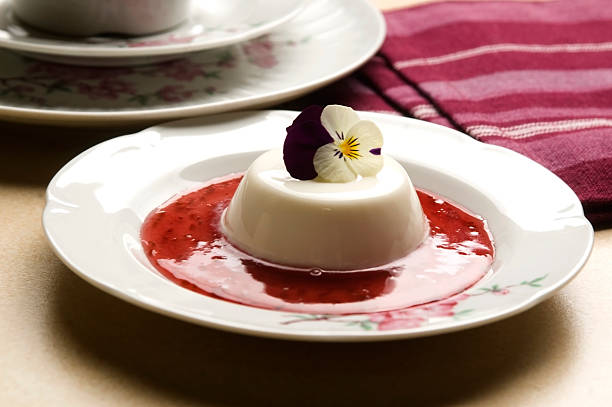 istock Vanilla panna cotta with berry sauce and spring flower 153209164