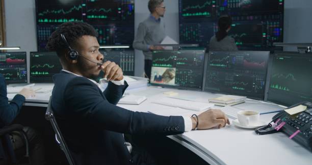 istock African American male trader works at computer 1532097918