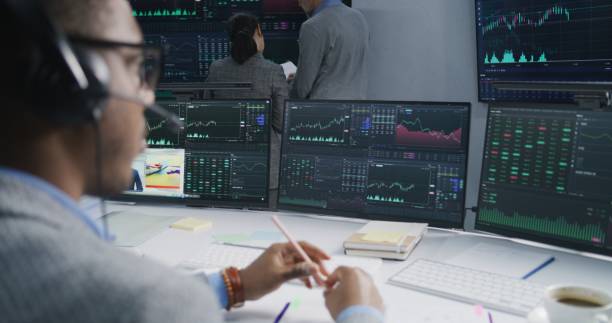 istock Analysts analyze market charts on big screens 1532102404