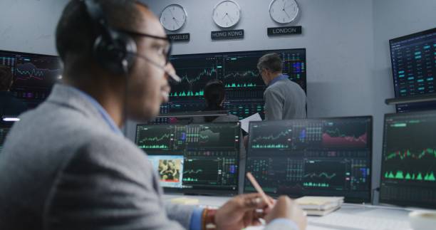 istock Analysts analyze market charts on big screens 1532103464