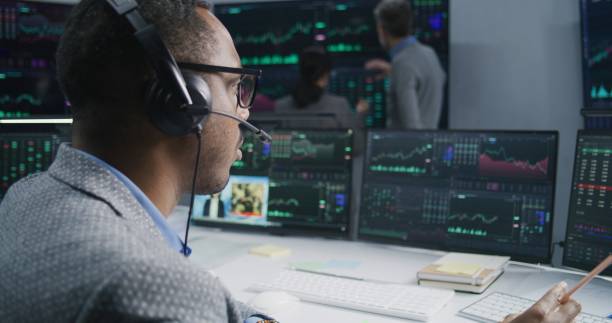 istock Analysts analyze market charts on big screens 1532104501