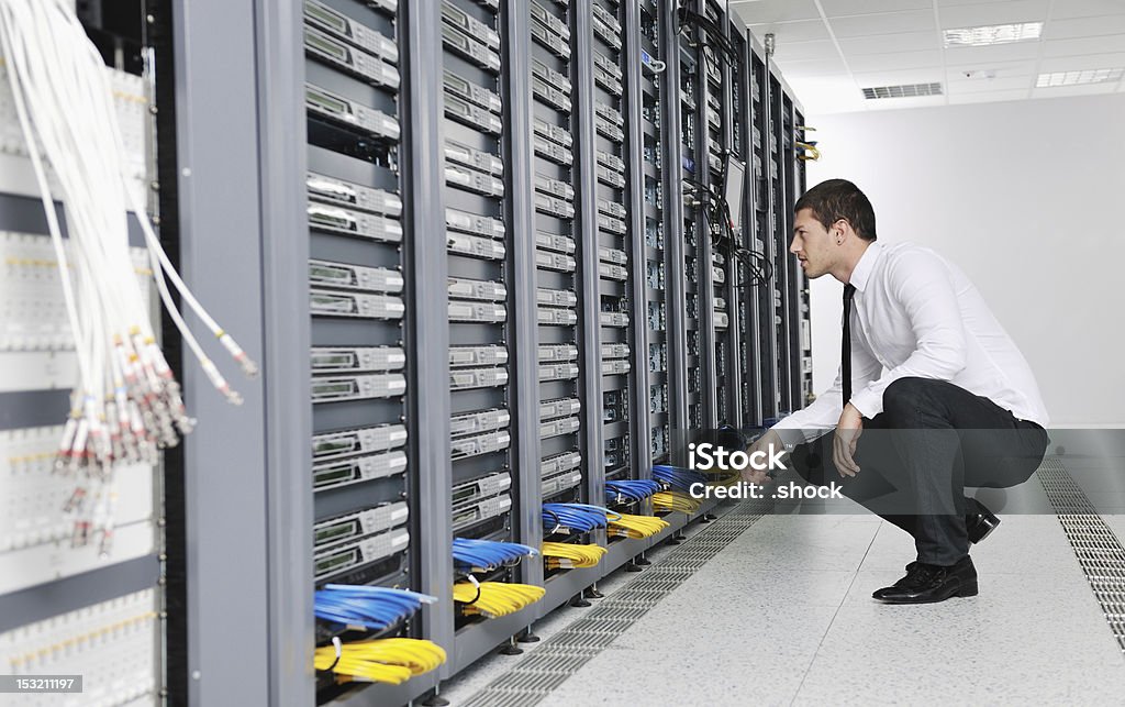 Young businessman in company server room young handsome business man  engeneer in datacenter server room Adult Stock Photo