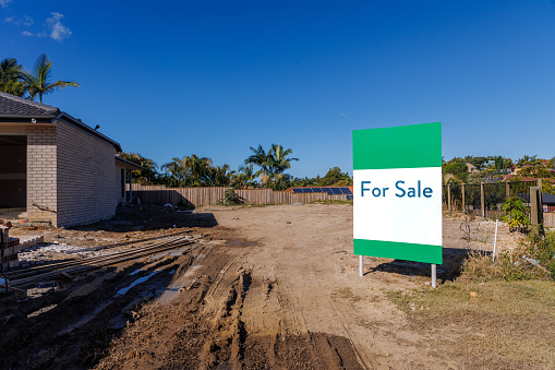 For sale sign on vacant block of land in residential housing development