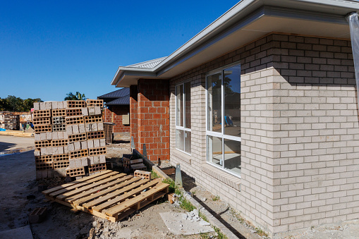 House under construction in residential housing development nearing lock-up stage
