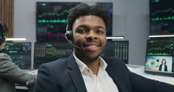 istock African American trader in headset looks at camera 1532140614
