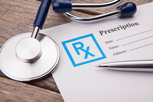 Stethoscope and Prescription in doctors desk.