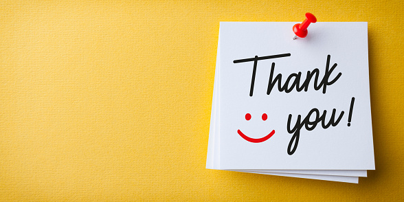 Happy Thank You on Yellow Cardboard Background