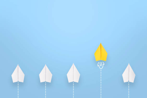 istock Leadership concepts with yellow paper airplane leading among white 1532147151