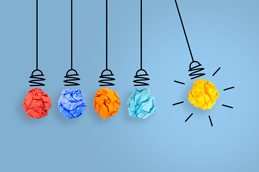 Innovative Idea Concepts with Light Bulb Crumpled Paper on Blue Background