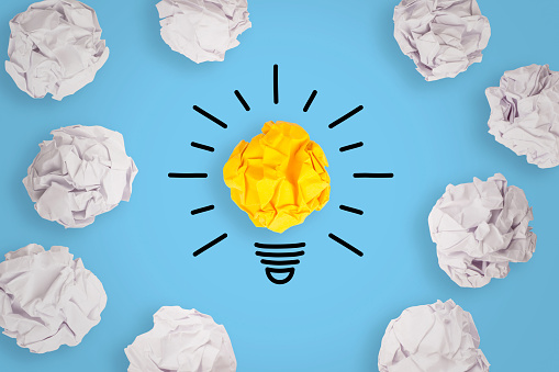 Creative Idea Concepts with Light Bulb Crumpled Paper on Blue Background