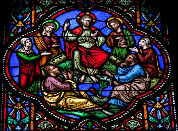 Jesus preaching Stained glass window depicting Jesus Christ preaching to a circle of followers. This window is located in the cathedral of Brussels, Belgium, and was created before 1866. apostle worshipper stock pictures, royalty-free photos & images