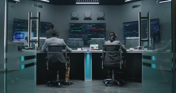 istock Team of traders work on multi-monitor computers 1532154379
