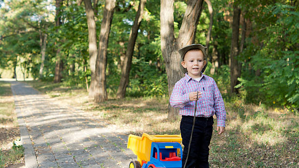 istock Little boy pulling a toy truck 153216667