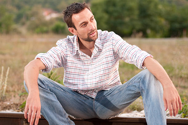 istock young man sits on the railway 153218840