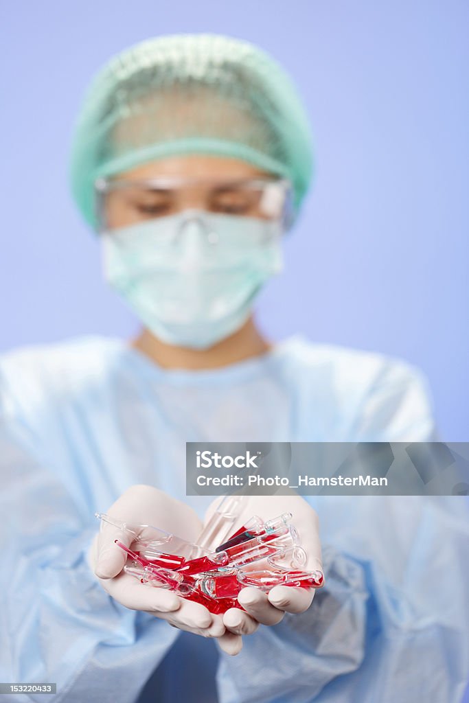 Doctor (woman) holding many medical ampoules in her hands Adult Stock Photo