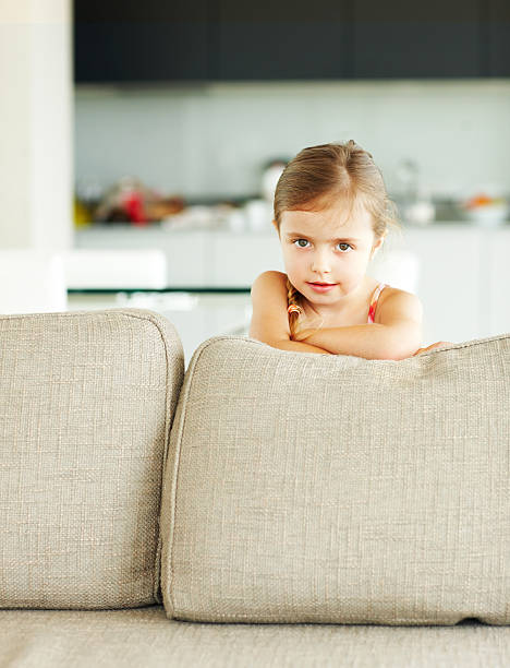 istock Portrait of a girl standing behind sofa 153220711