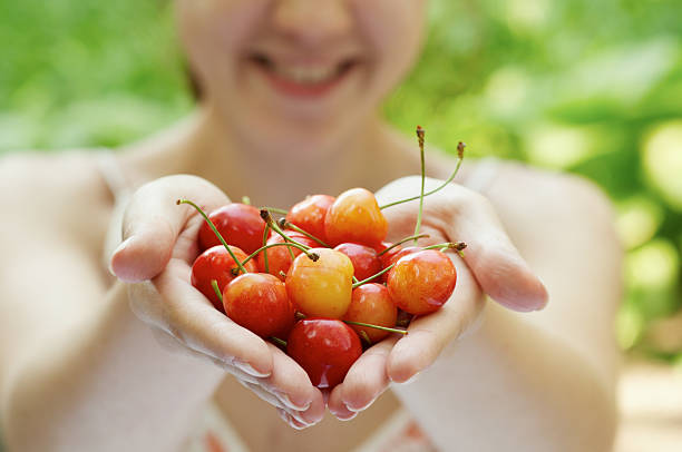 istock she holds a handful of cherries 153220897