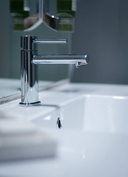 Modern bathroom sink and faucet, shallow DOF.