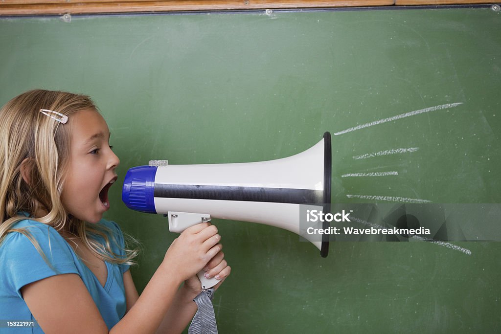 Jeune écolière hurlant dans un porte-voix - Photo de Bruit libre de droits