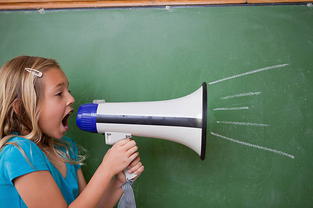 istock Young schoolgirl screaming through a megaphone 153221971