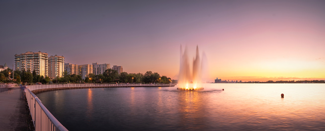 The Peace Fountain is located in a public park in Windsor, Ontario, Canada.  It is on the Detroit River.  Across the river is Detroit, Michigan, USA.