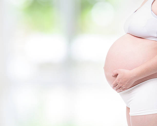 istock expectant mother touching her belly by hands 153222463