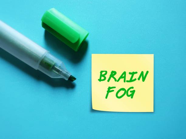 Green highlight pen write on stick note BRAIN FOG, a term used to describe feelings of mental fuzziness, inability to think clearly, occurs when the brain is overworked or under strain lápiz verde resaltado escribir en nota de palo niebla cerebral, un término utilizado para describir sentimientos de confusión mental, incapacidad para pensar con claridad, ocurre cuando el cerebro está sobrecargado de trabajo o bajo presión.