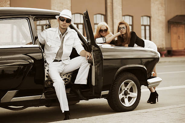 istock Young people with a retro car 153227420