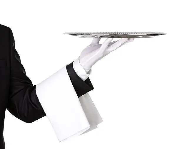 Close up of a waiter's arm holding silver tray isolated on white background