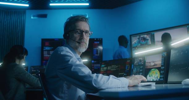 istock Flight control employee in headset looks at camera 1532282474