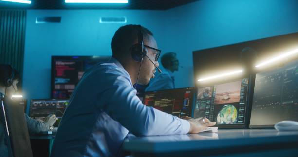 istock African American flight control employee monitors space mission 1532284011