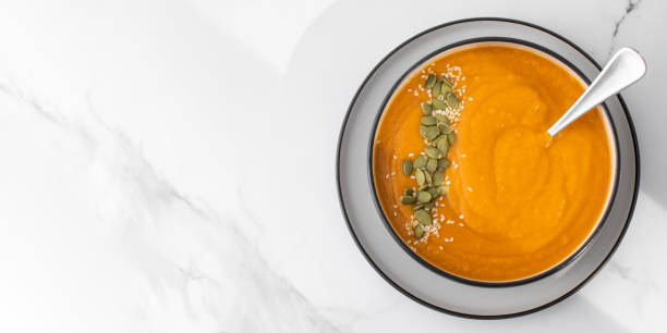 istock A bowl of pumpkin soup with mashed potatoes and seeds. Autumn menu. Copy space 1532297049