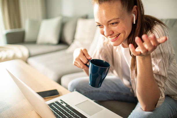 istock Young woman using a laptop at home 1532298996