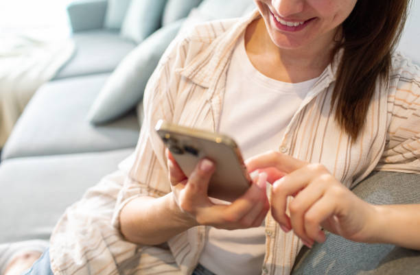 istock Young woman using a smart phone at home 1532306391