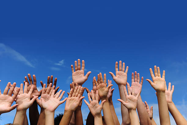Hands Against Blue Sky Stock Photo - Download Image Now - Hand Raised, Sea  Of Hands, Sky - iStock