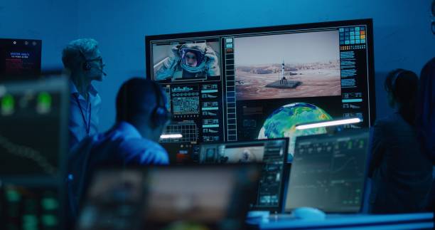 istock Flight control operators monitor space mission on computers in command center 1532320783