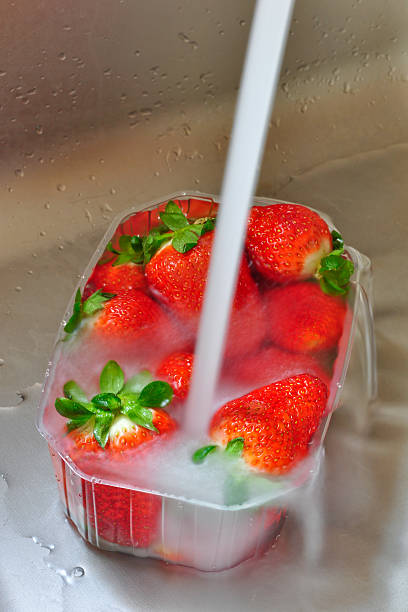 istock Washing a basket of fresh strawberries 153232753
