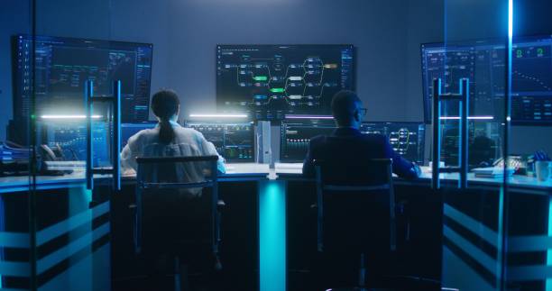istock Diverse IT technical specialists work on computers in monitoring office 1532331106