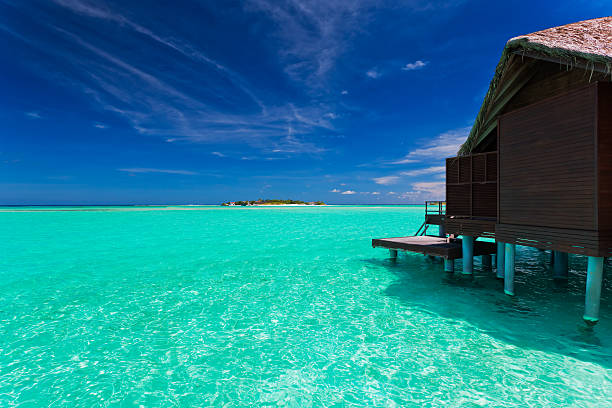 istock Overwater bungalow in lagoon around tropical island 153233676