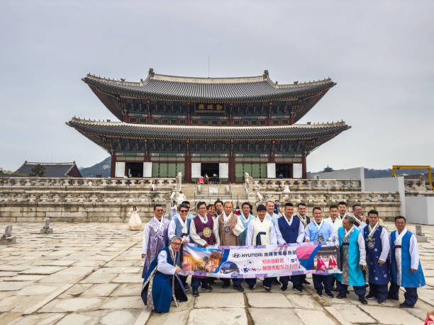 Tourists wearing traditional hanbok dresses in Gyeongbokgung Palace, Seoul, South Korea. Seoul, South Korea - March 23, 2023.