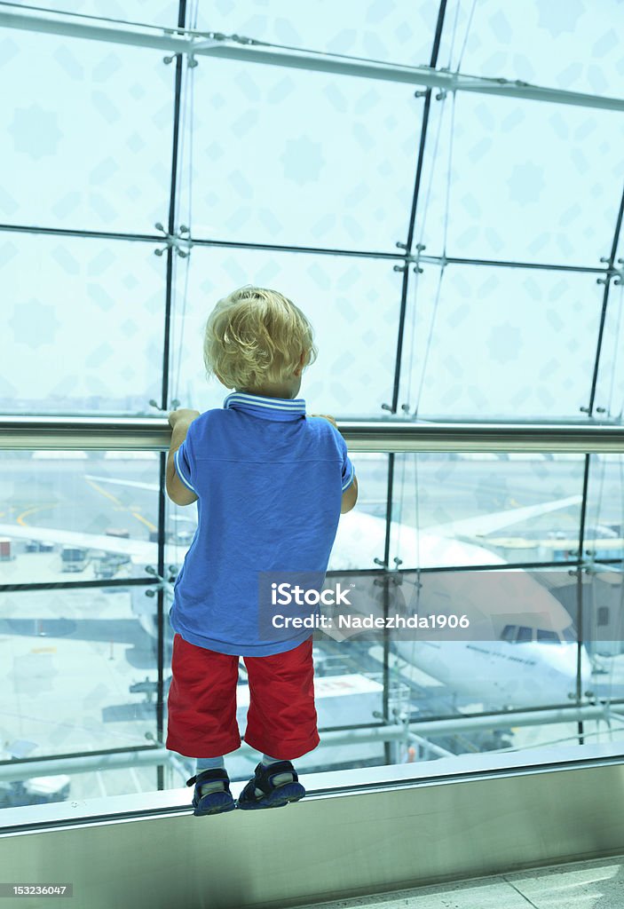 Baby watching planes Boy looking at planes in the airport Airplane Stock Photo