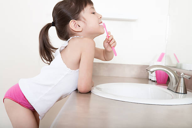 Girl Brushing Teeth Stock Photo - Download Image Now - Girls, Underwear,  Brushing Teeth - iStock