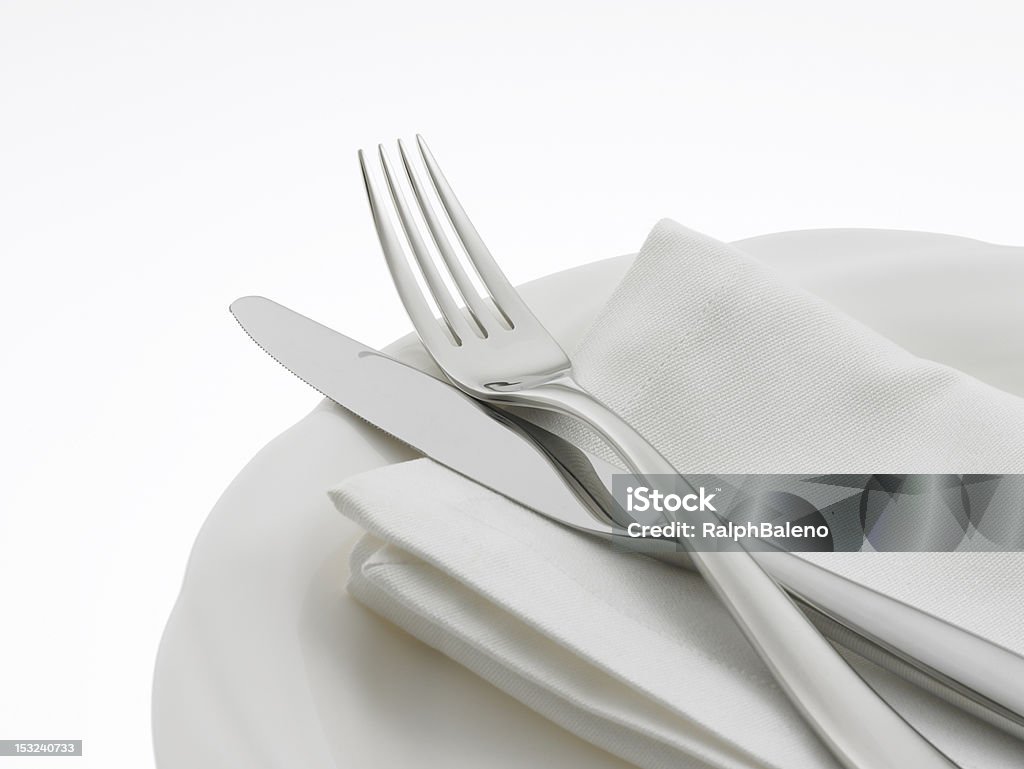 Napkin and Flatware on dinner plate Elegant flatware on a napkin, on a dinner plate. Napkin Stock Photo