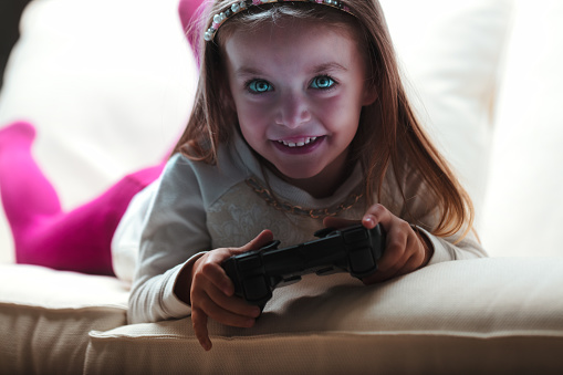 cyborg Girl gaming on sofa, supervised, enjoys challenges