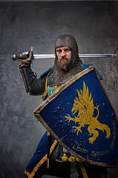 istock Medieval knight with blue armor on a grey rock background 153243863