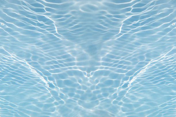 istock Blue water with ripples on the surface. Defocus blurred transparent blue colored clear calm water surface texture with splashes and bubbles. Water waves with shining pattern texture background. 1532455920