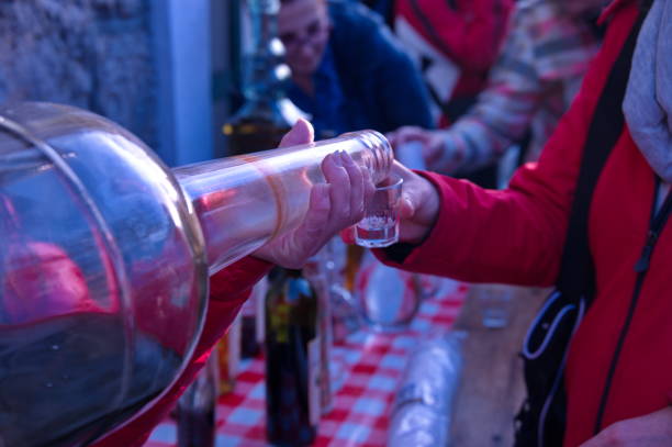 istock Woman pouring brandy from big bottle 1532459687