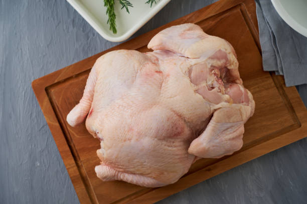 istock Uncooked whole raw chicken on a cutting board 1532462251